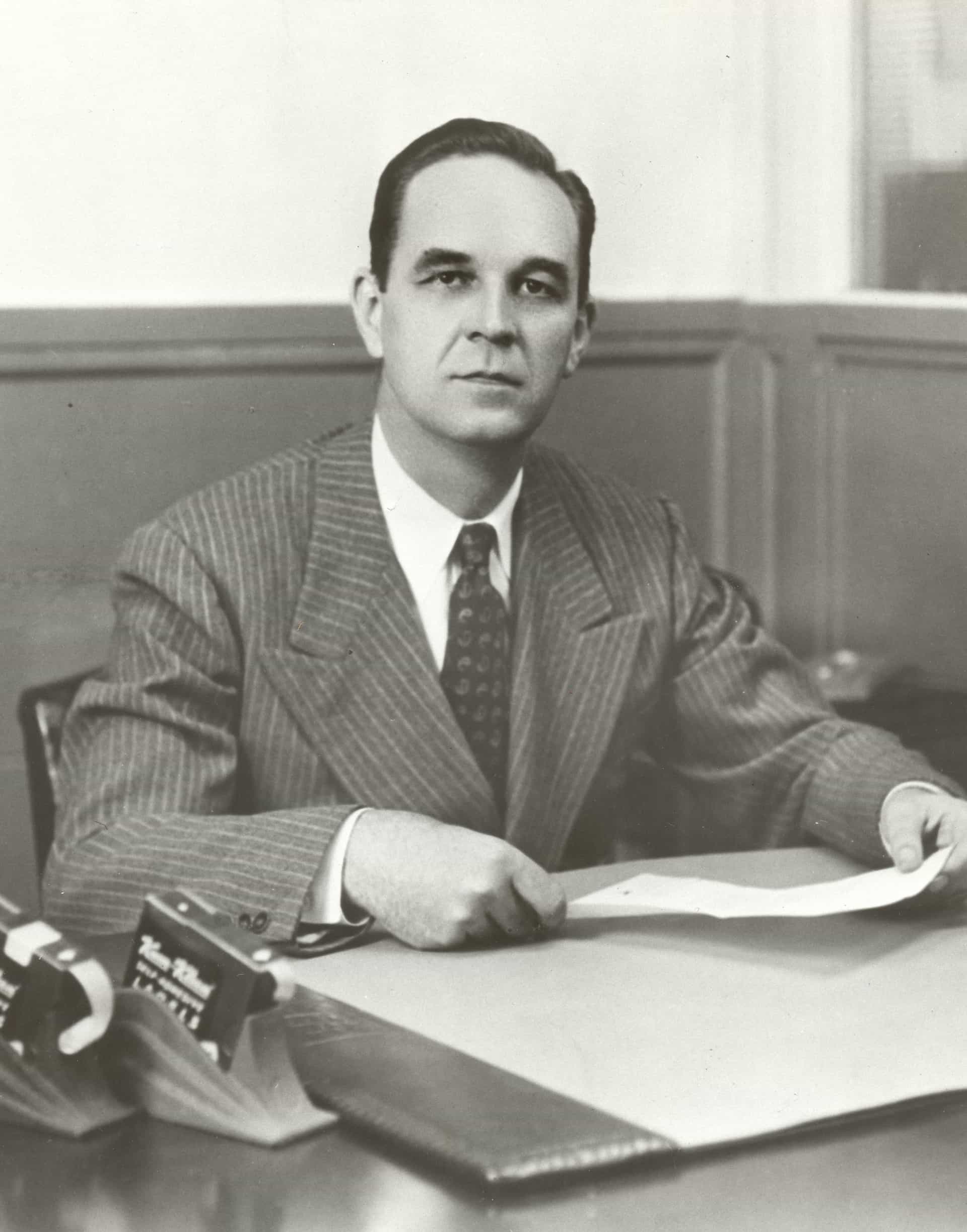 ad-lpm-cpg-stan-avery-sitting-at-desk-archival