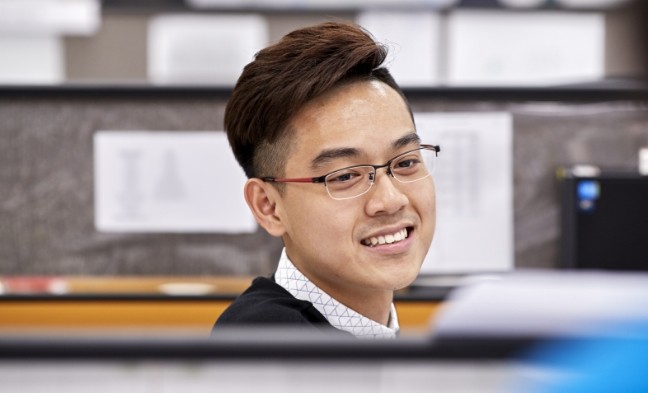 Avery Dennison employee smiling in their workspace.