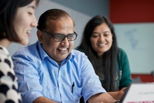 Team members looking at notes in a meeting room.
