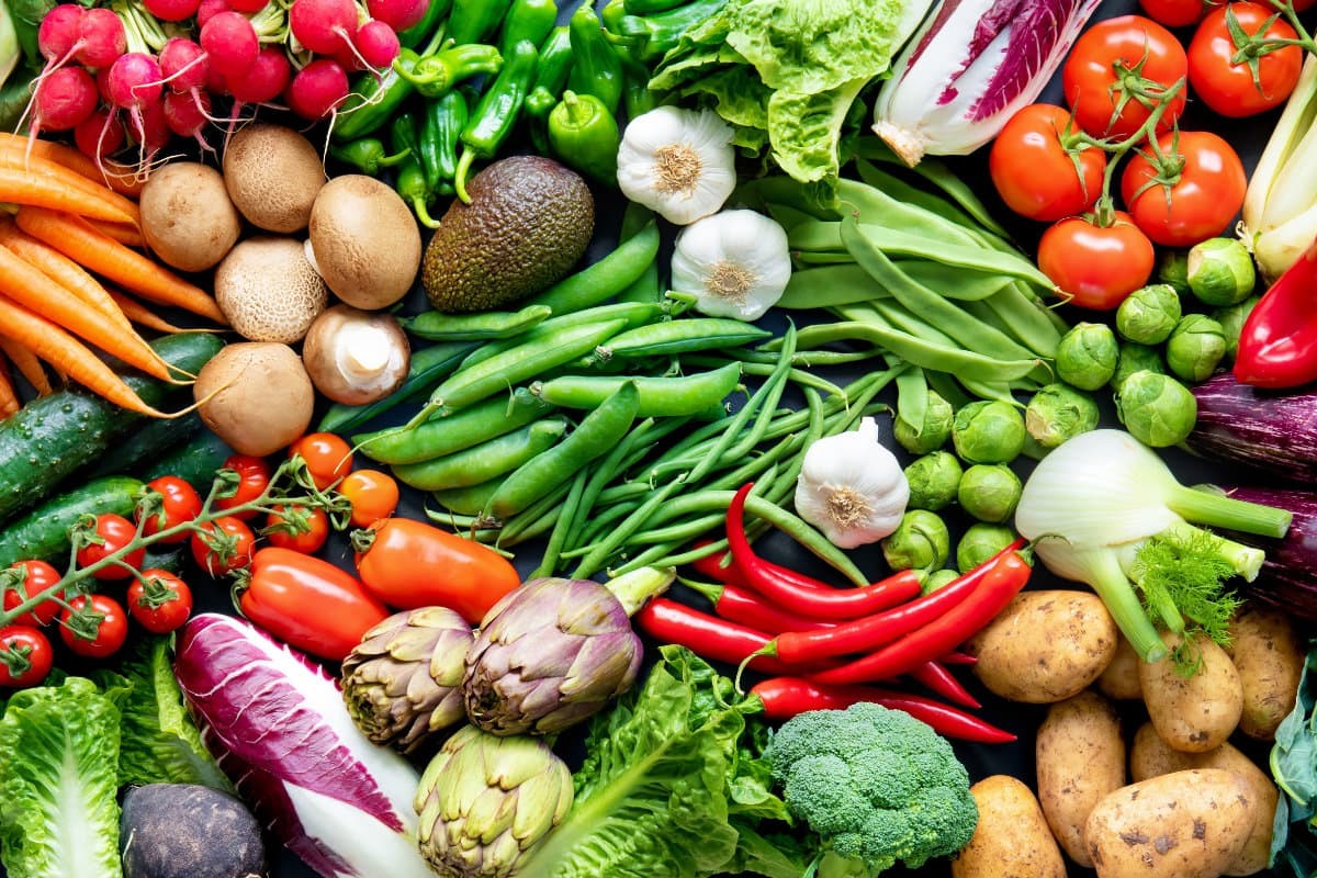 Vegetables and other produced arranged on a table.