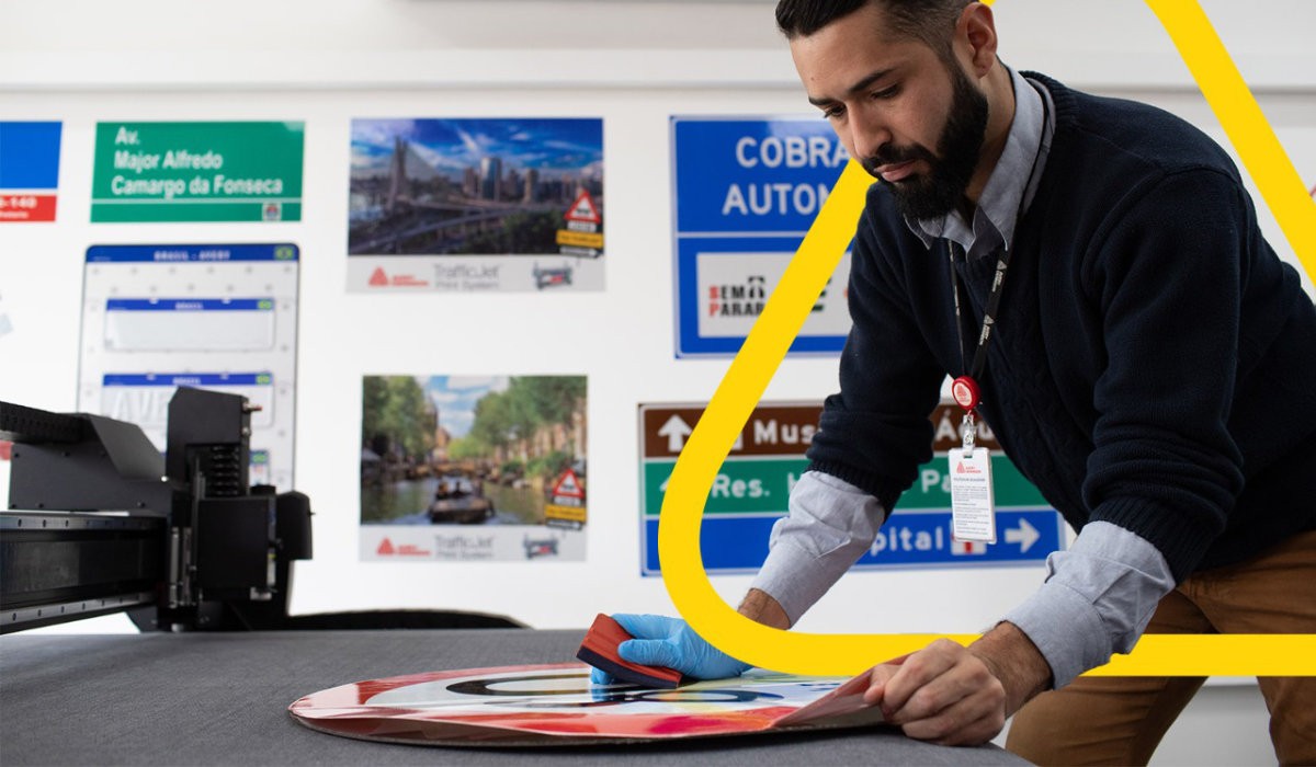 Sign shop worker creating a traffic sign.