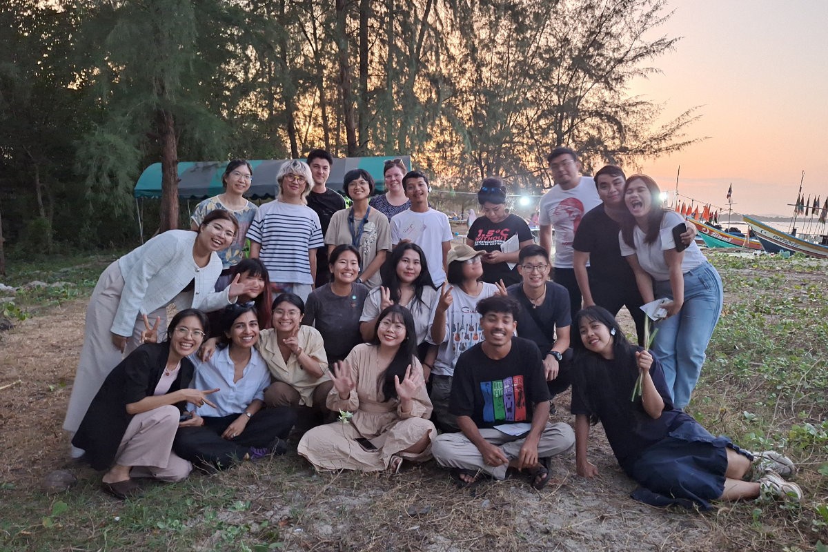 Friends gathered at beach event.