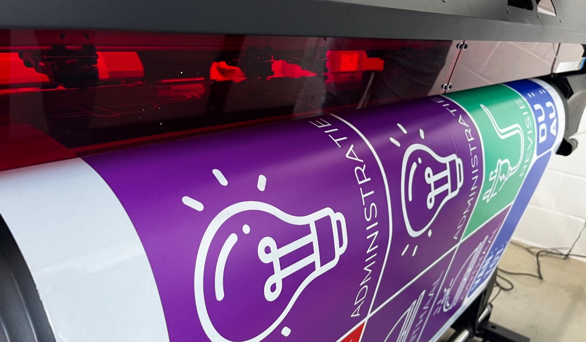 Closeup image of printed TrafficJet signs coming out of printer.